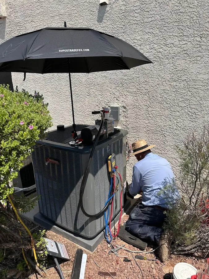 HVAC technician performing outdoor AC maintenance in Whitestown